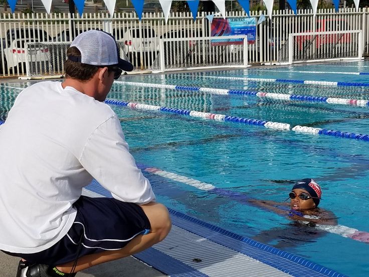 Coach demonstrating technique poolside